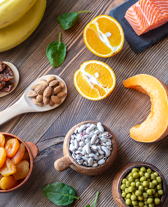 Photo of high potassium foods including bananas, dried fruits, nuts, and apricots.