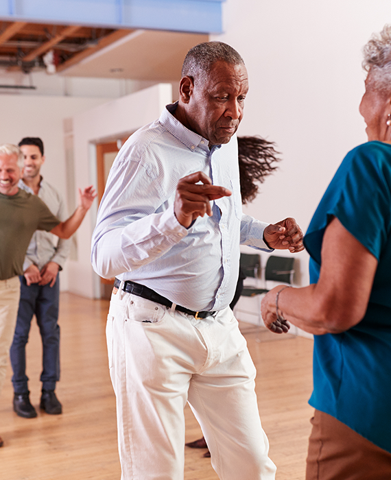 Older couple, dancing in a dance class
