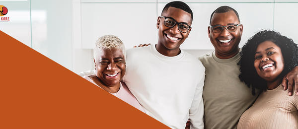 Image of a smiling multi-generational family, arms around one another