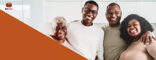 Image of a smiling multi-generational family, arms around one another