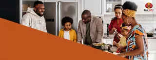 Image of a family gathered in the kitchen, smiling and laughing